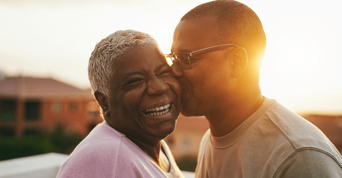 Person kissing another person on the cheek