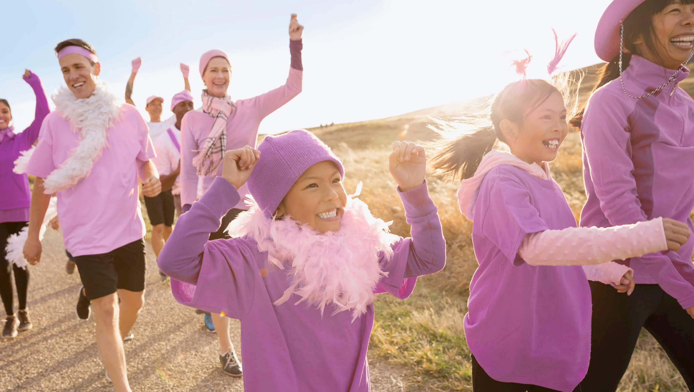 Photo of team fundraising event with participants wearing purple.