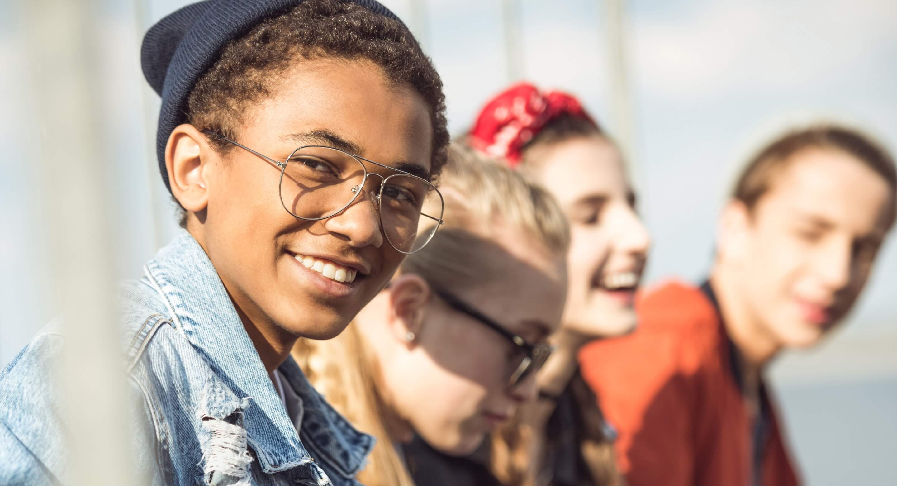 Smiling teen boy with friends