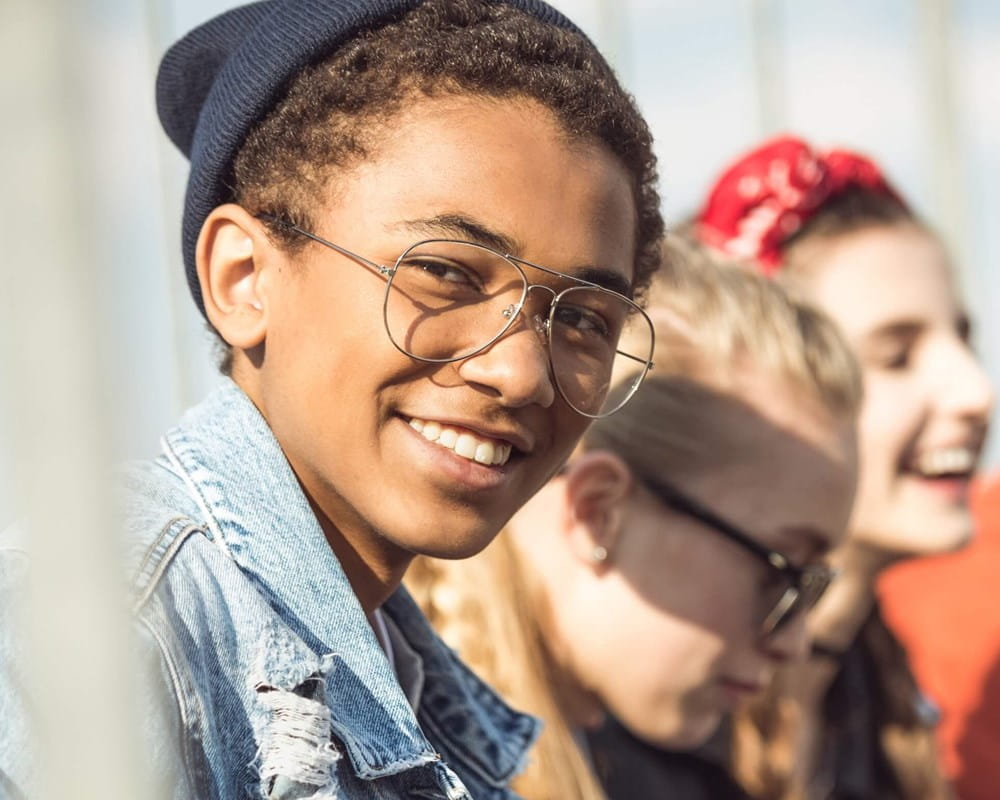 Smiling teen boy with friends