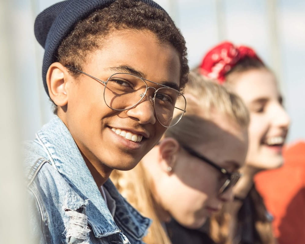 Smiling teen boy with friends