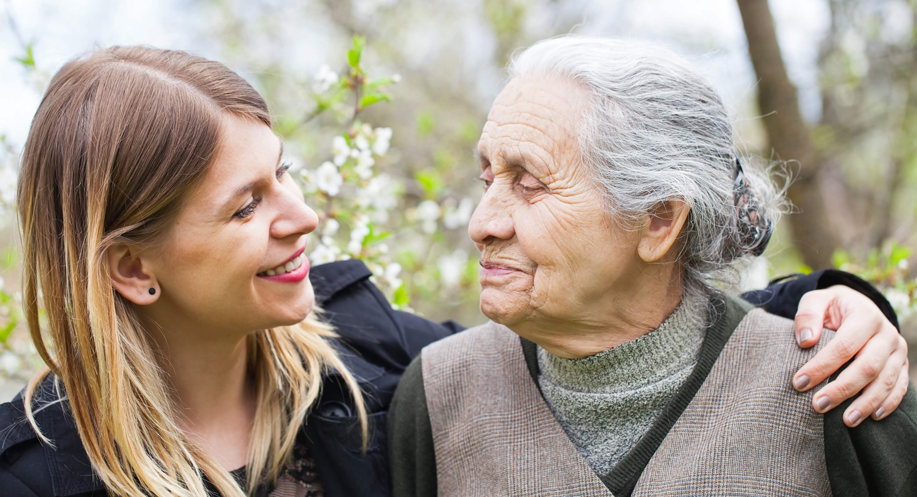 Younger woman hugging older woman