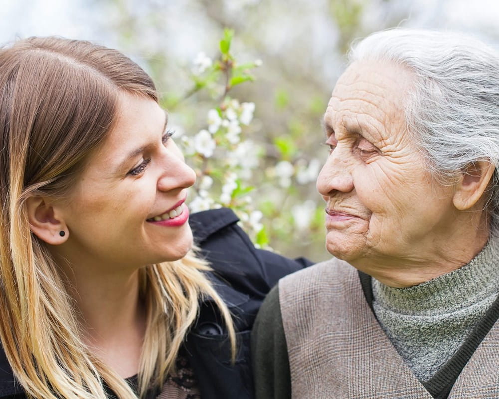 Younger woman hugging older woman