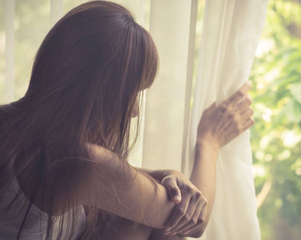 Girl looking outside window