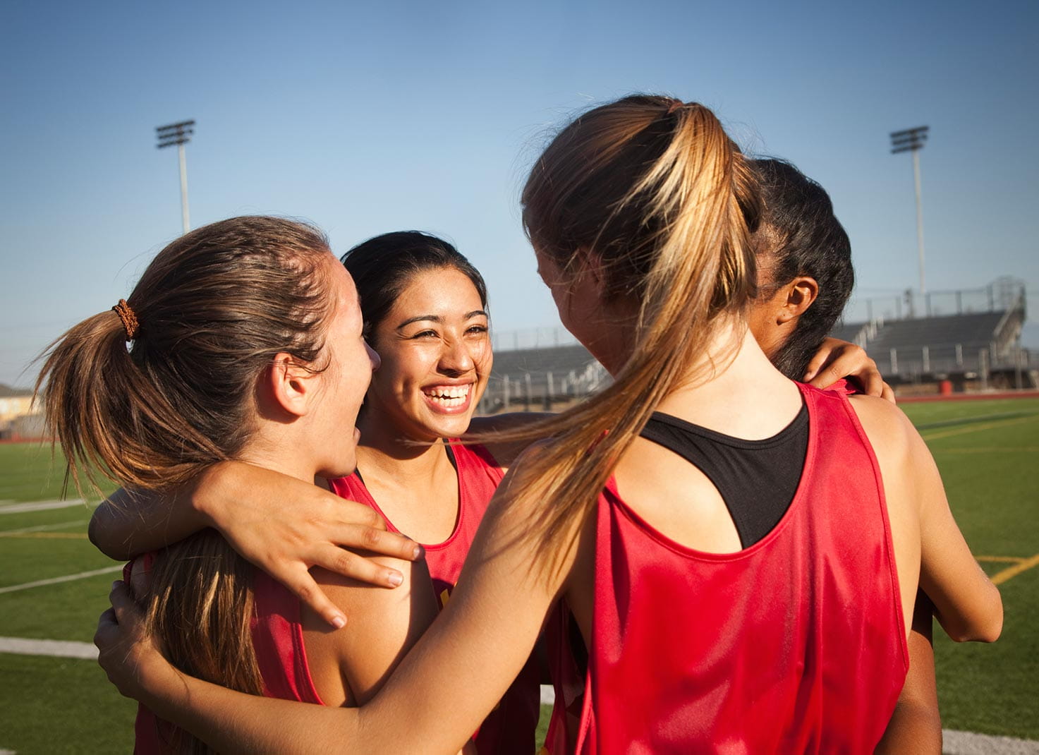 Four young women on a field together