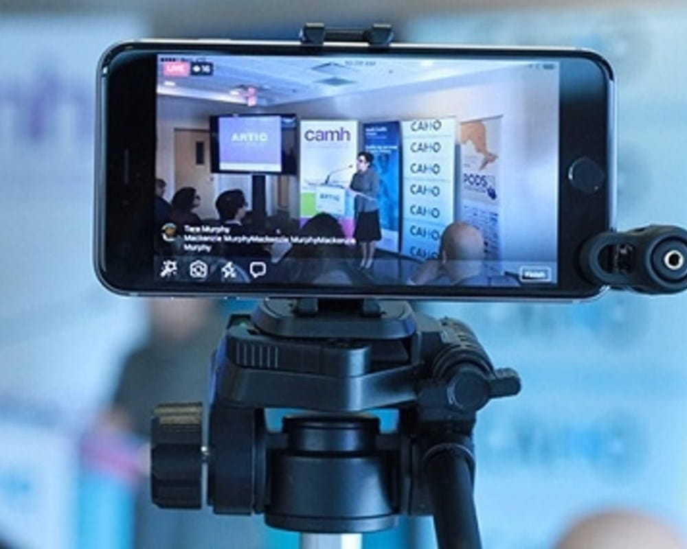 Smartphone being used to film news conference