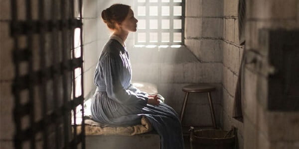 A scene in Alias Grace of Grace Marks sitting on her bed staring off into the distance.