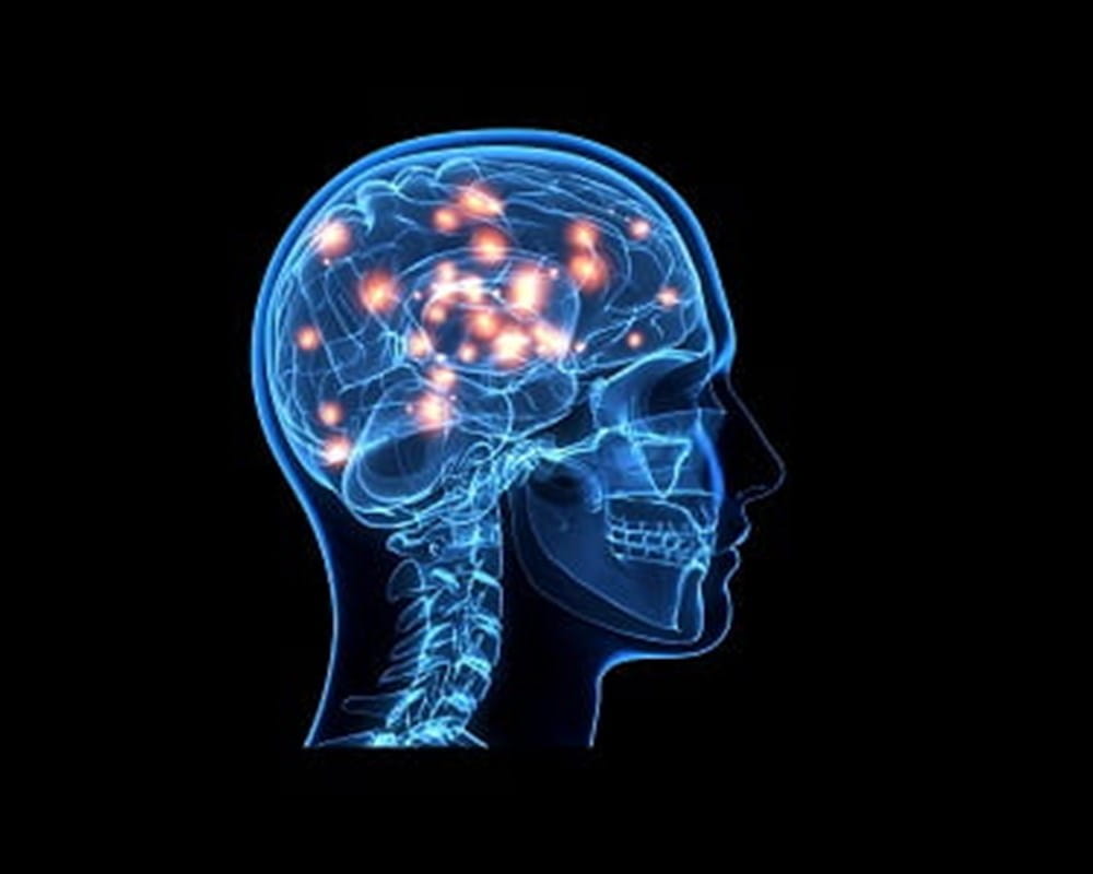 A side profile of a computer generated brain representing the mind and red lights showing the connections the brain makes.