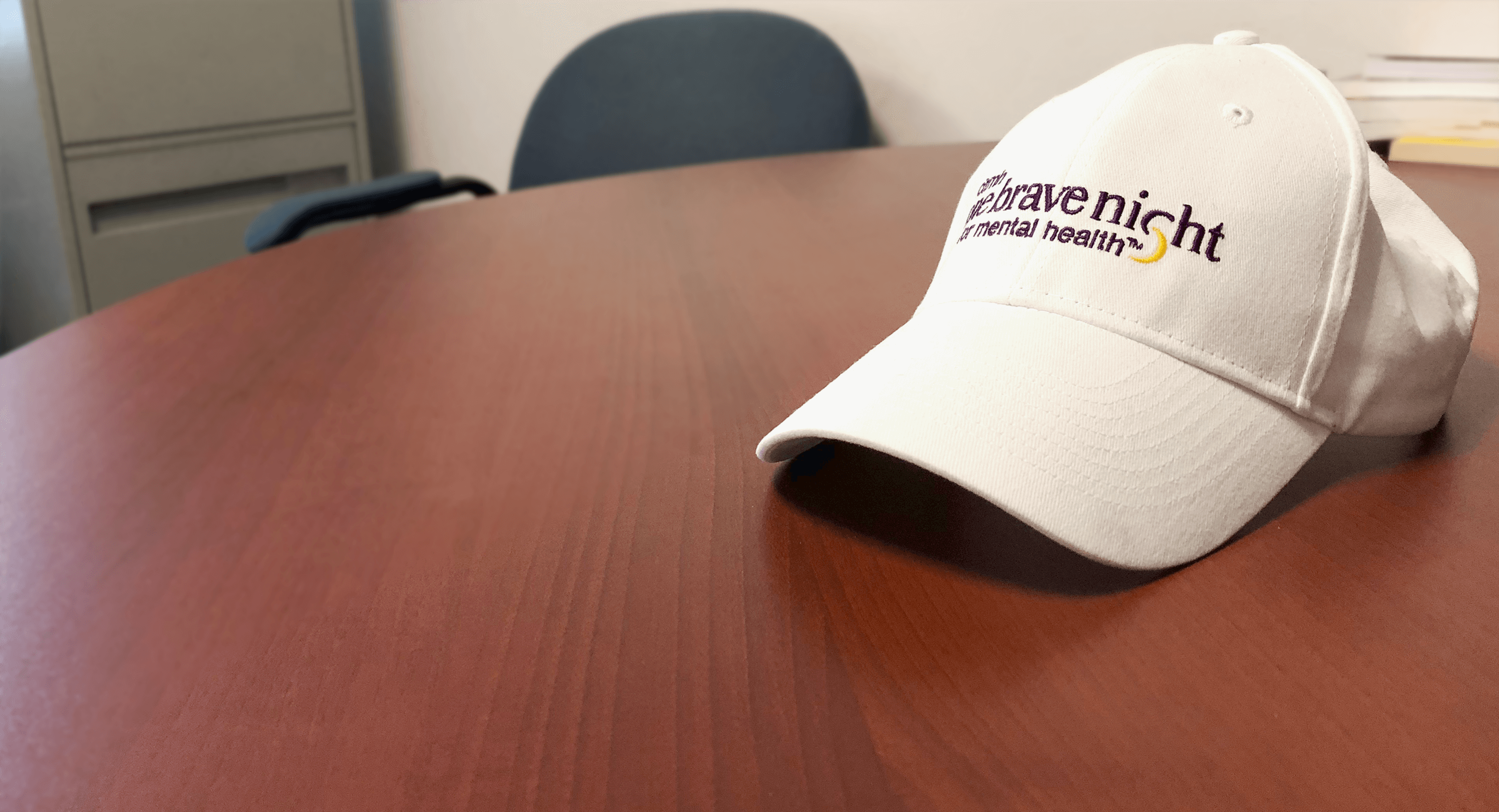 One Brave Night hat sits on table