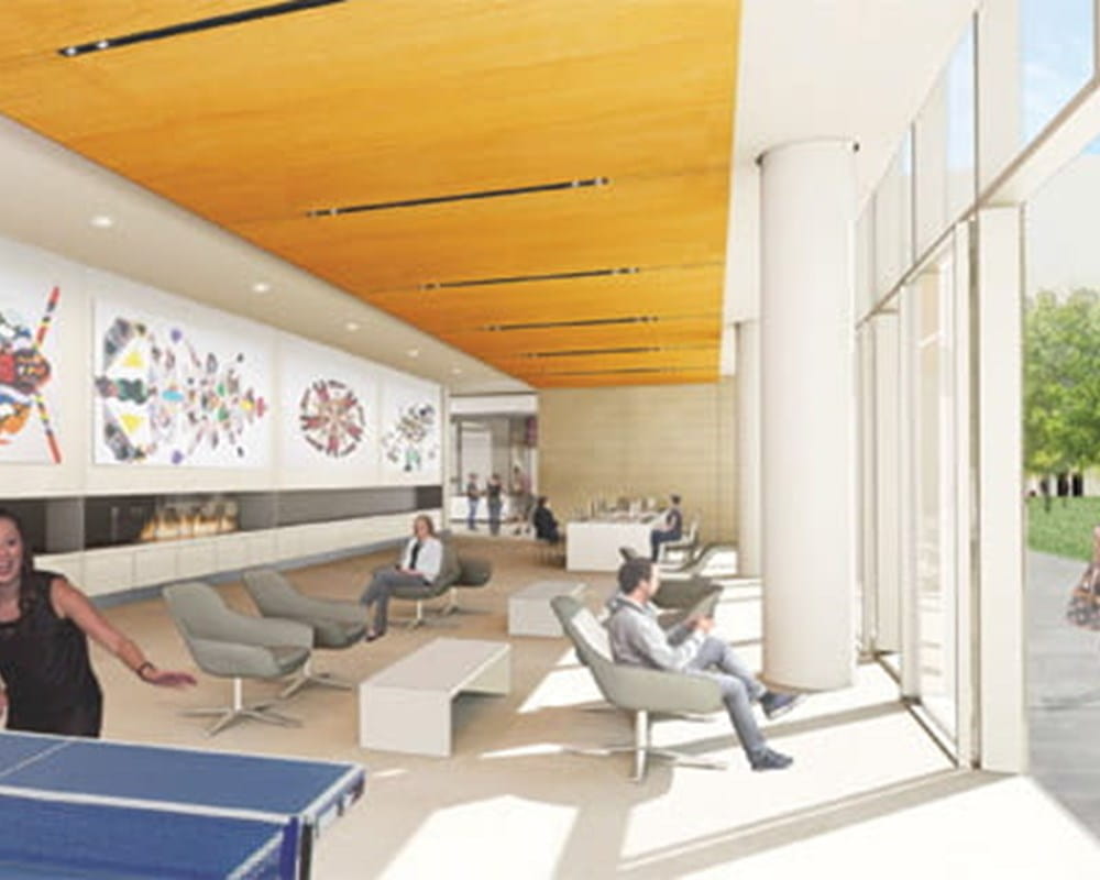 A Client Recovery Mall with chairs, a woman playing at a ping pong table and distinct artwork covering the walls.