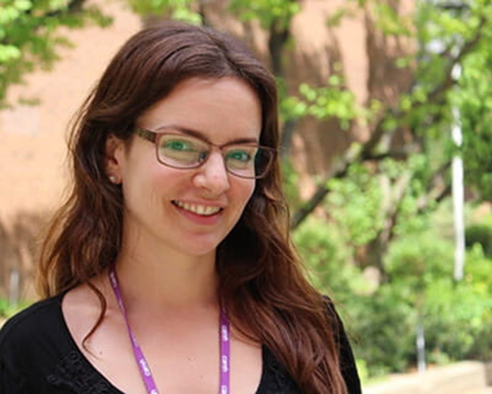A medium-close up shot of a CAMH social worker wearing glasses and a purple lanyard.