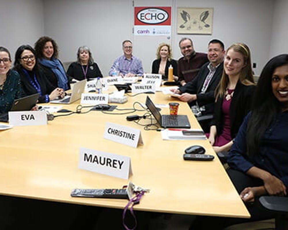 The Echo Team sitting around a large round table.