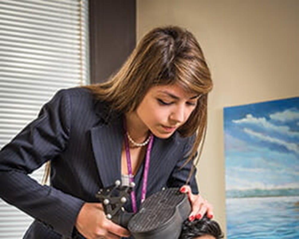 Dr. Faranak Farzan shows an example of non-invasive brain stimulation therapy