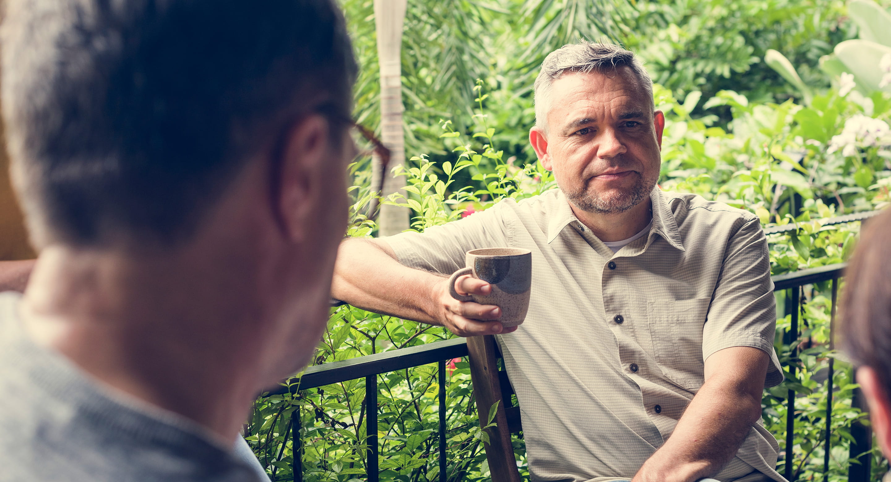 Men having coffee and having a chat.