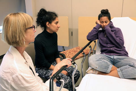 A professional actor plays the part of a teen patient during a mental health simulation. 