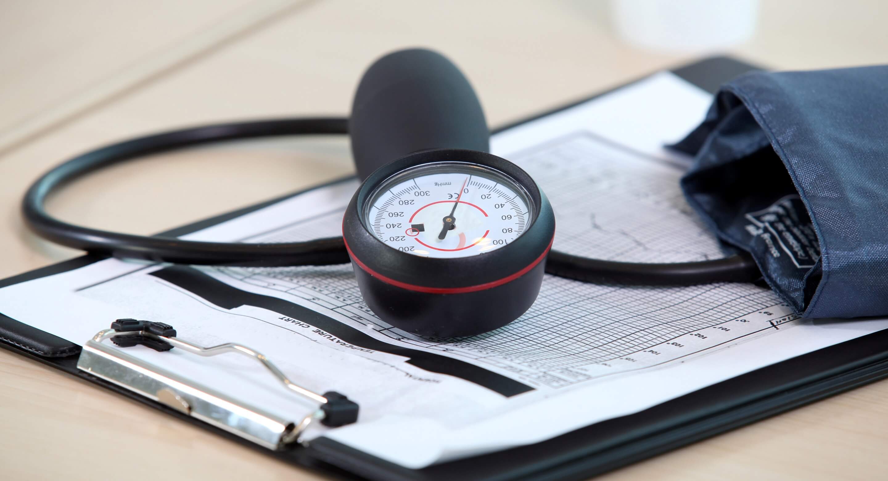 Blood pressure cuff and clipboard on a table