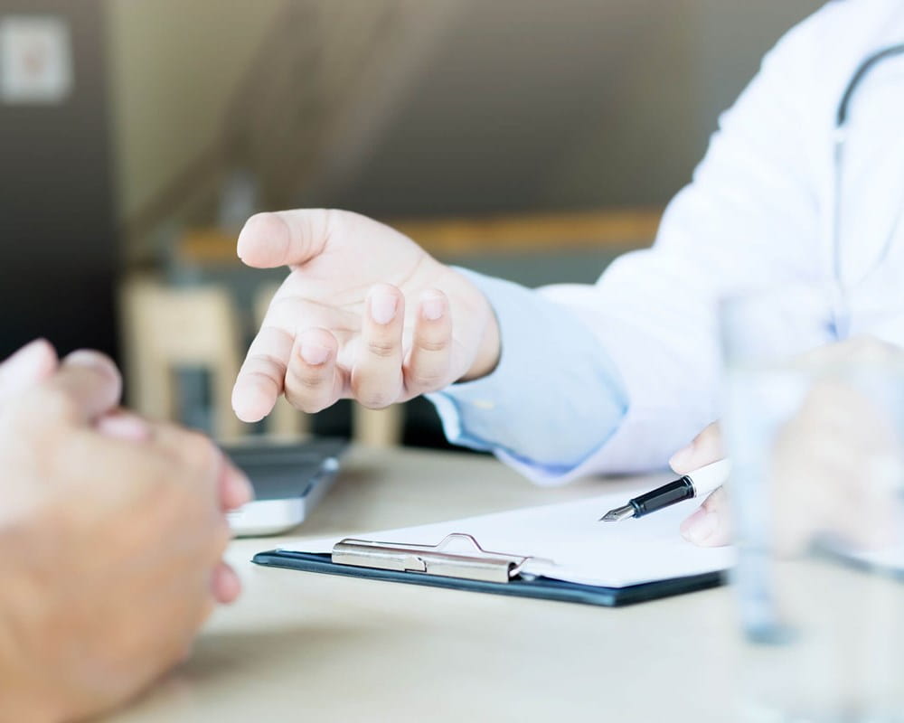 Image showing close-up of doctor and patient hands while they talk in doctor's office