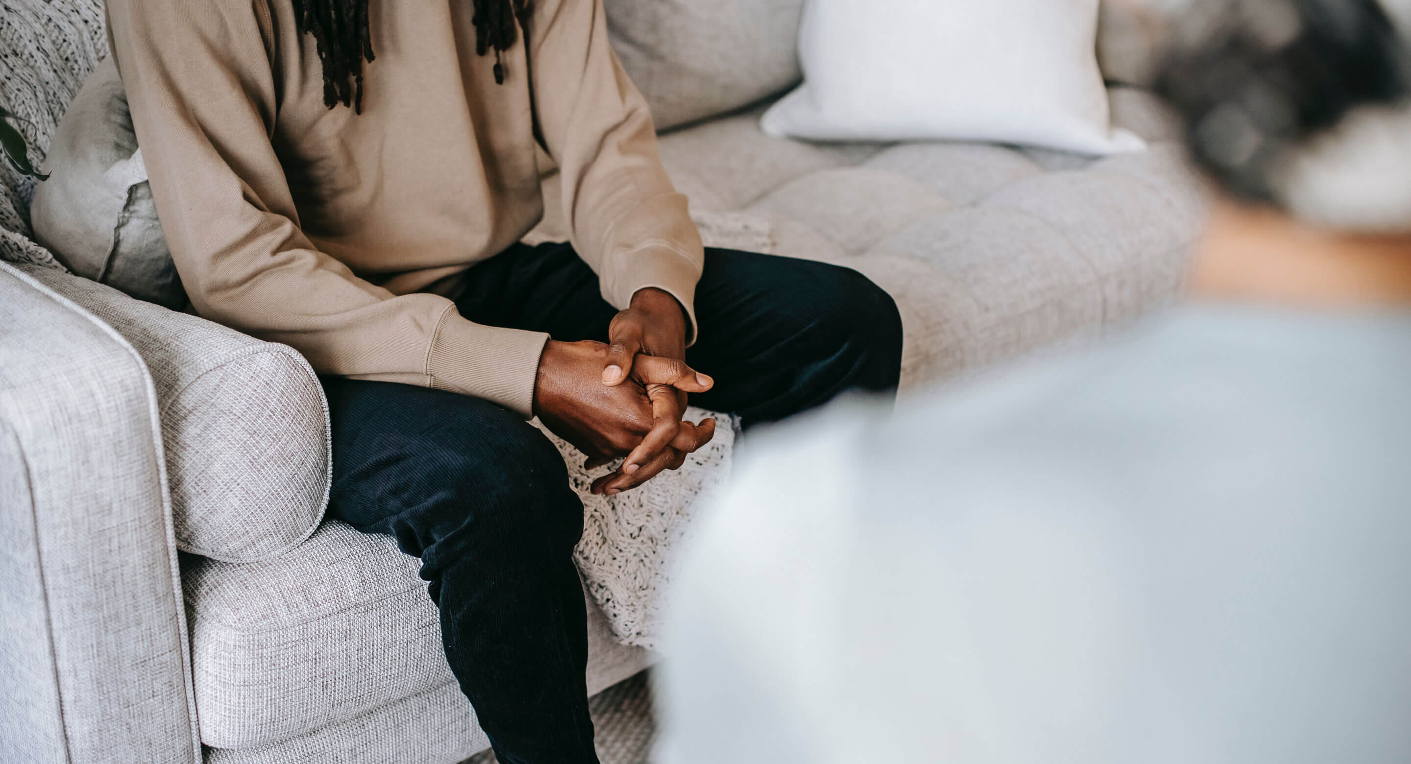 Person sitting on couch talking to person across from them