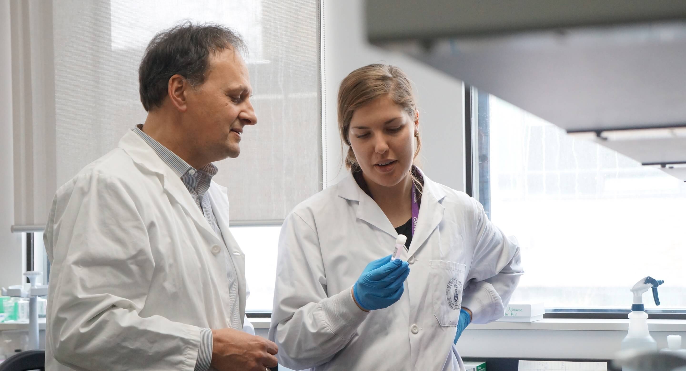 Dr. Etienne Sibille in the lab with another researcher