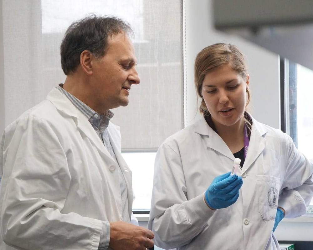 Dr. Etienne Sibille in the lab with another researcher