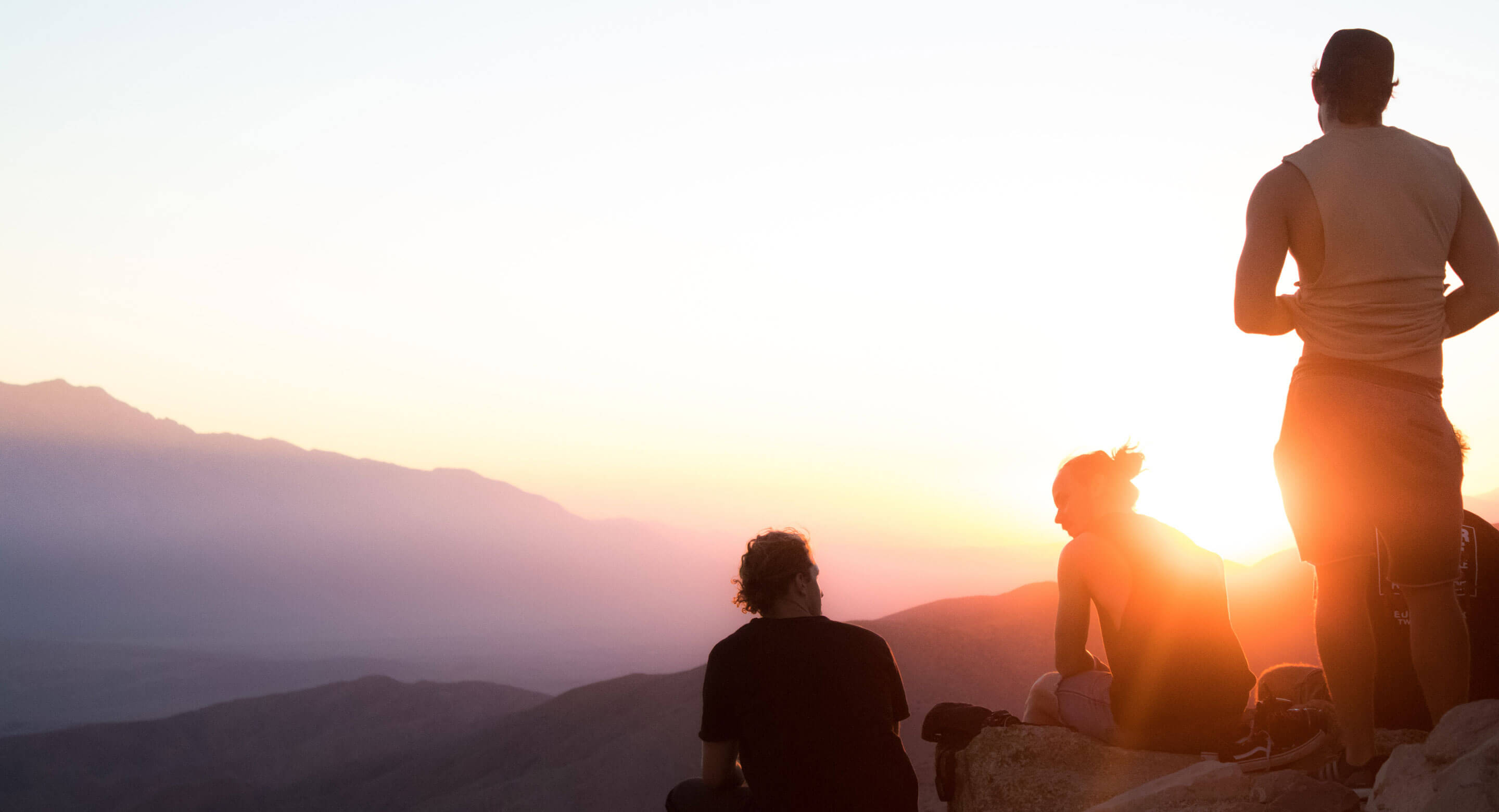 Stock photo of people in mountain watching sunrise/sunset