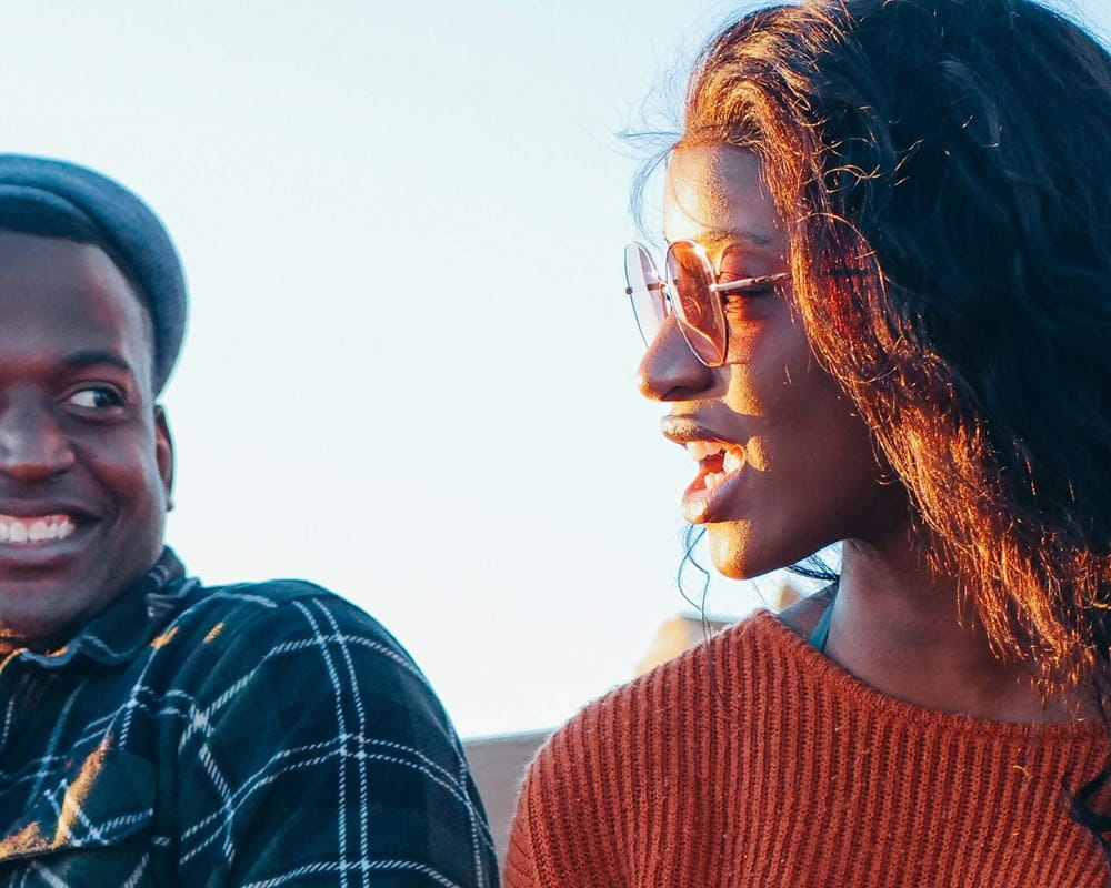 Two young people talking and smiling