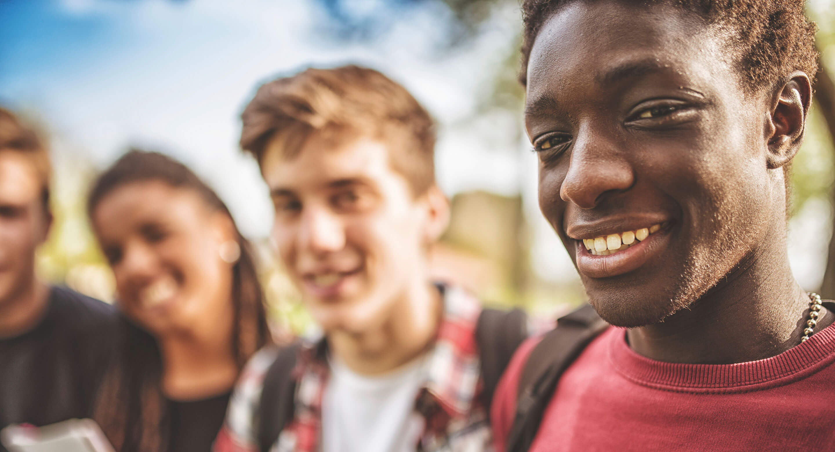 Stock photo showing young people smiling at the camera