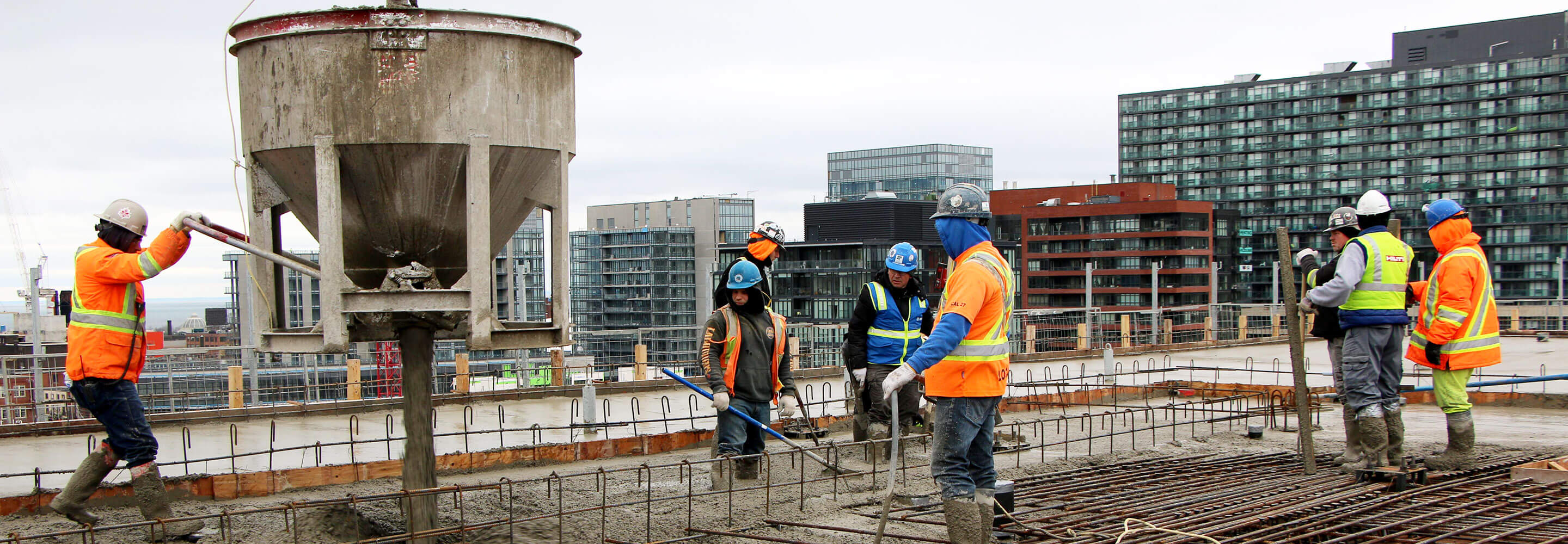 Man pouring concrete - top-off Phase 1C