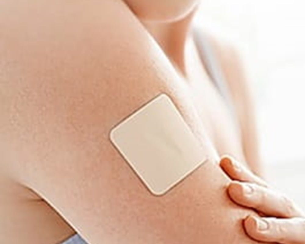 A nicotine patch on someone's arm.