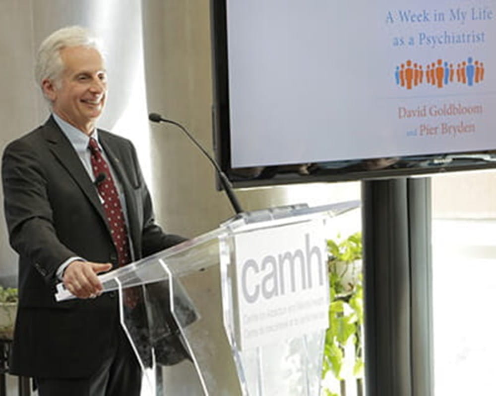 Pier Bryden speaking behind a podium.