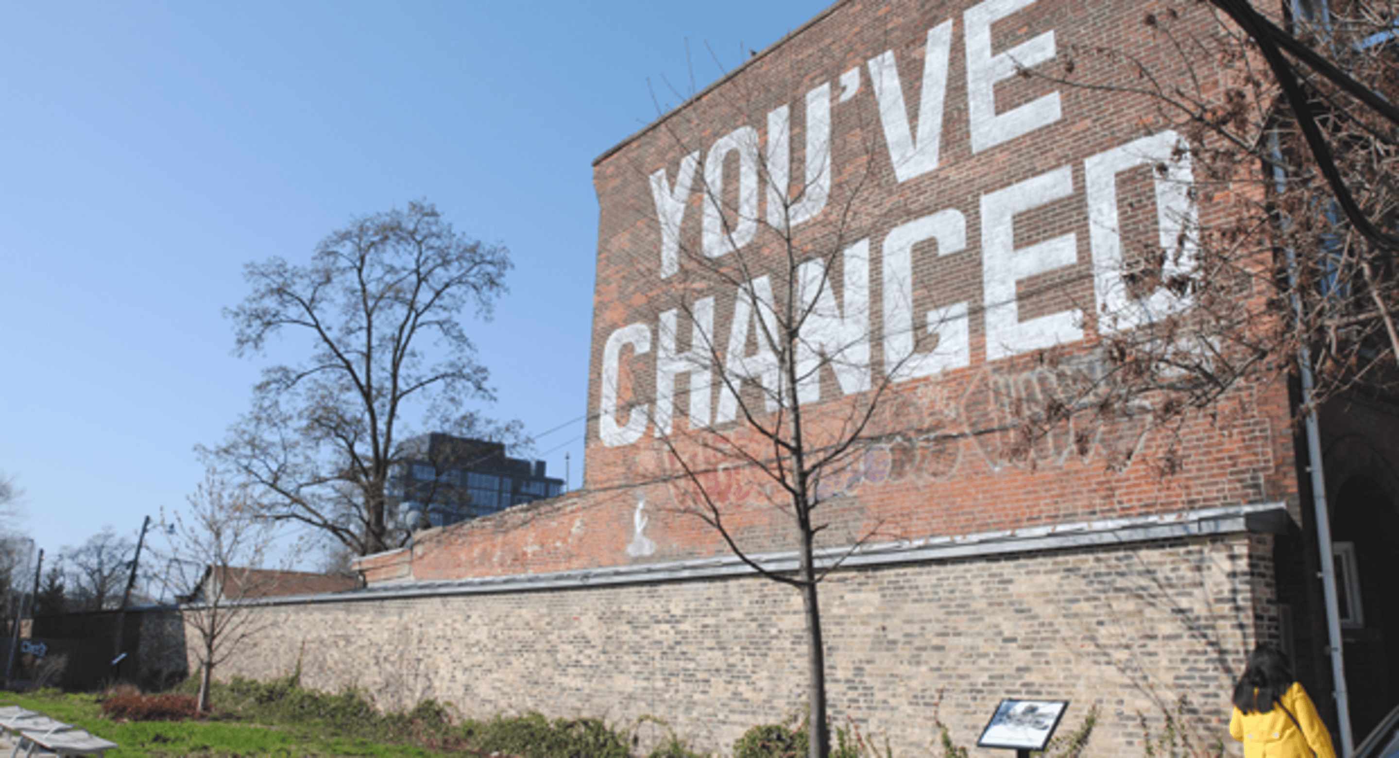 The side of a brick wall with the phrase 