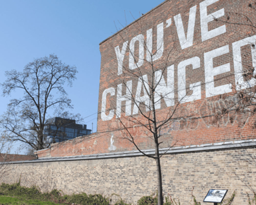 The side of a brick wall with the phrase