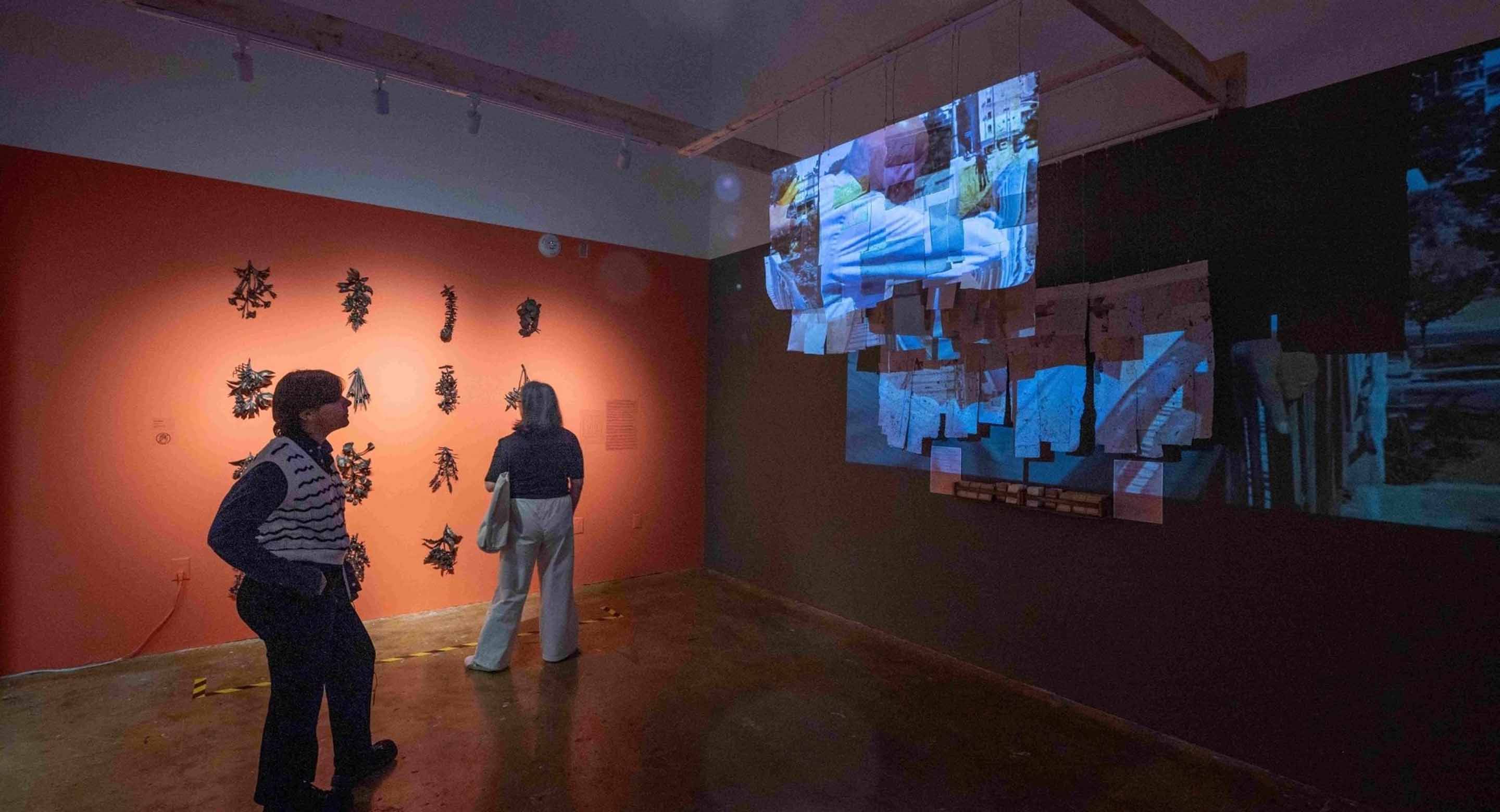 People viewing different art installations at the 2025 Being Scene exhibit presented by Workman Arts
