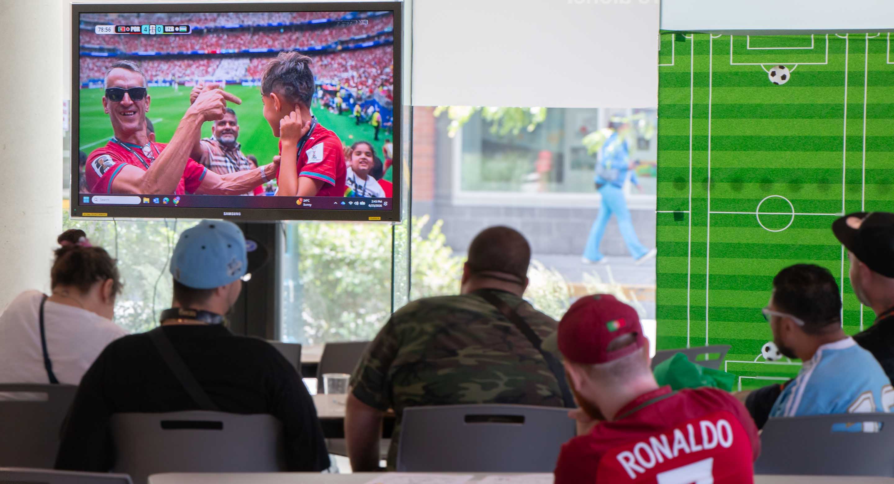 Group of people watching a soccer game