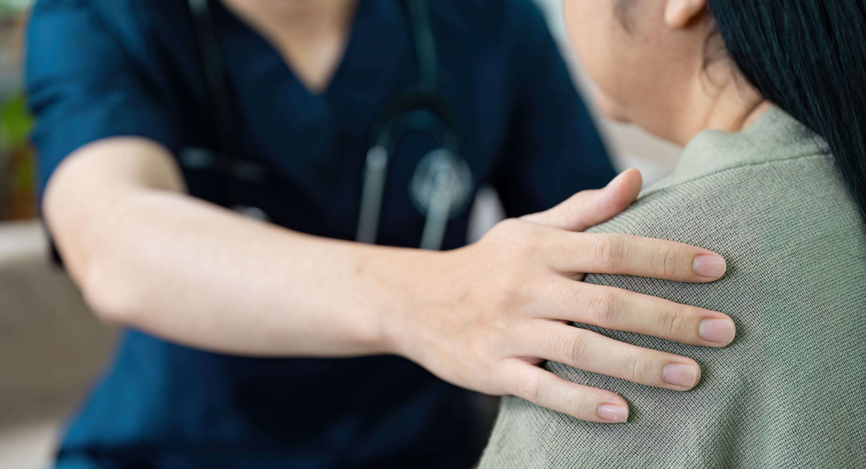 Healthcare worker comforting a patient