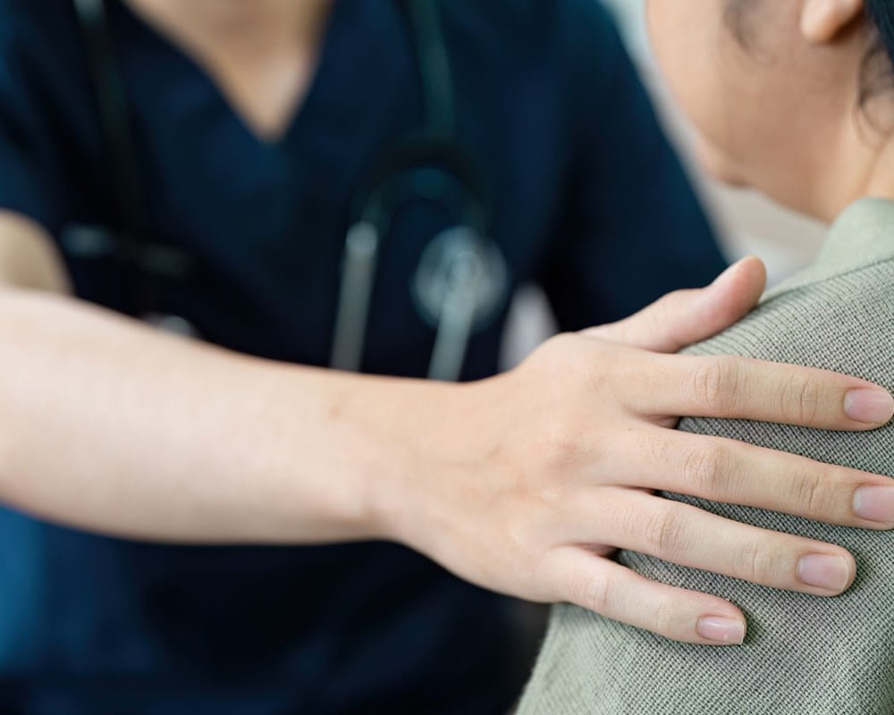 Healthcare worker comforting a patient