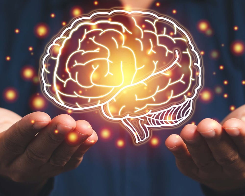 Image of a person holding up a virtual depiction of a brain
