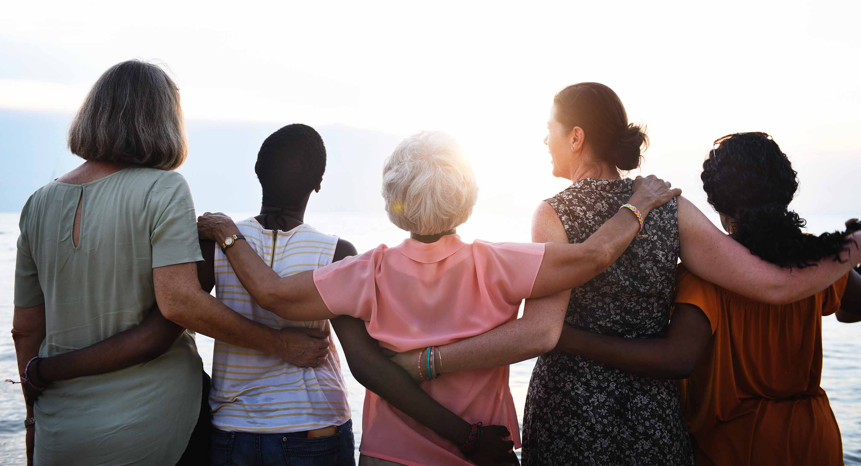 A group of women staring out into the sunset