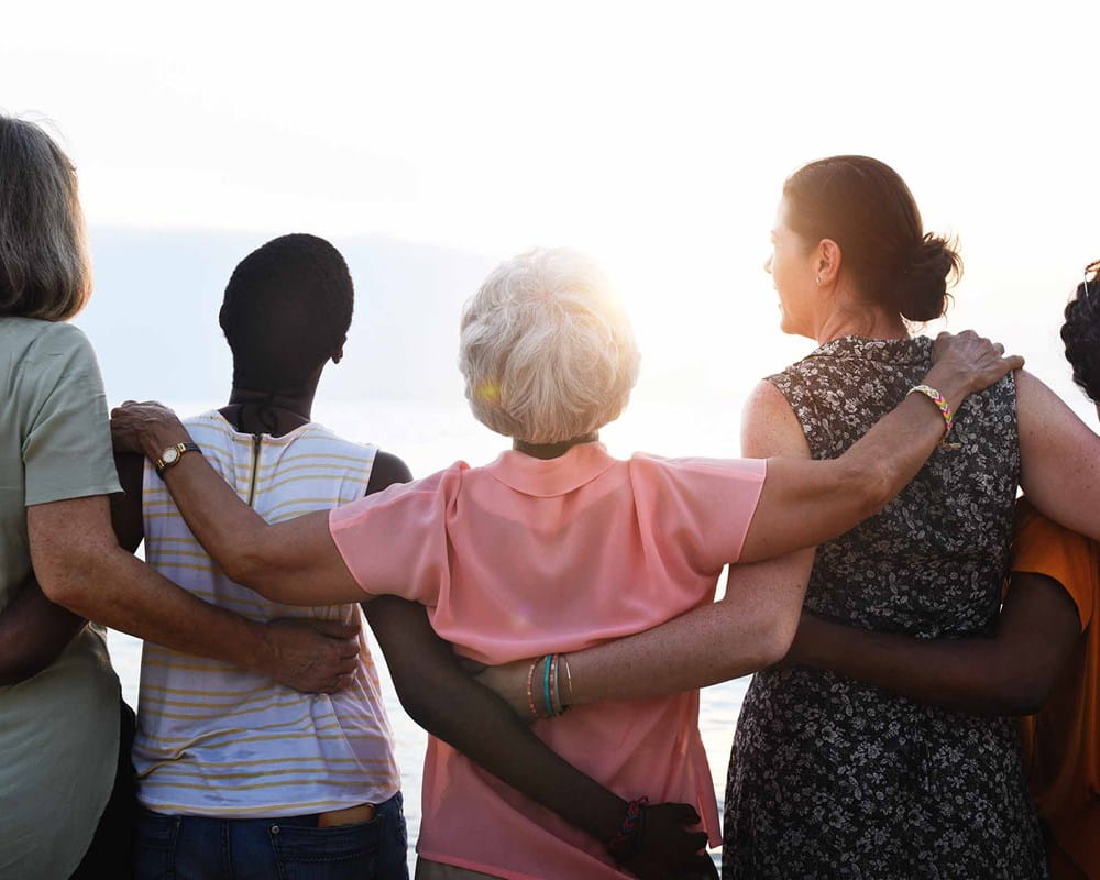 A group of women staring out into the sunset