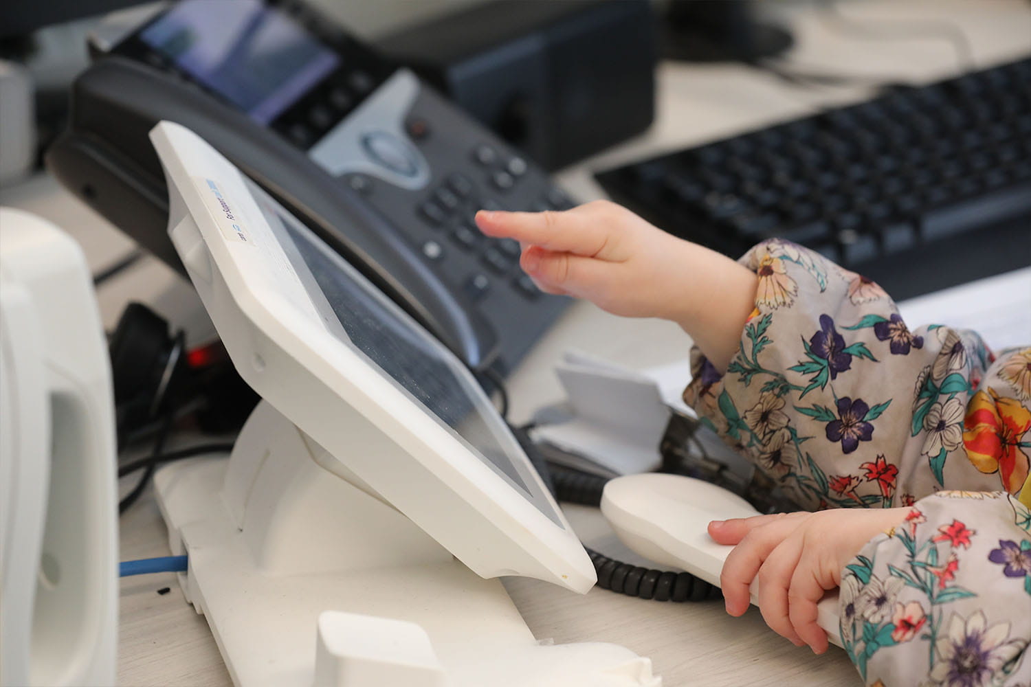 Child's hands pressing buttons on a phone