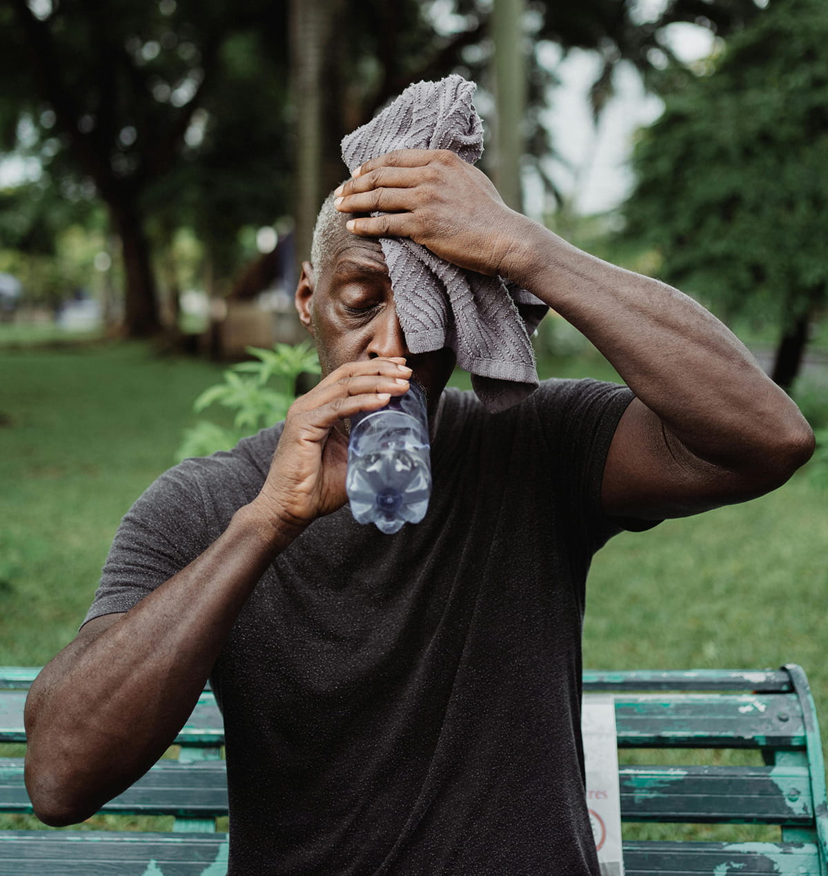 Man sweating and drinking water