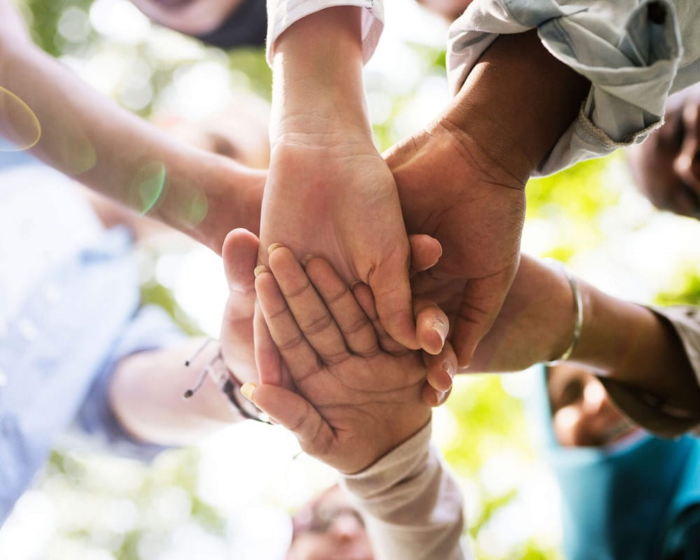 Diverse group of youth holding hands